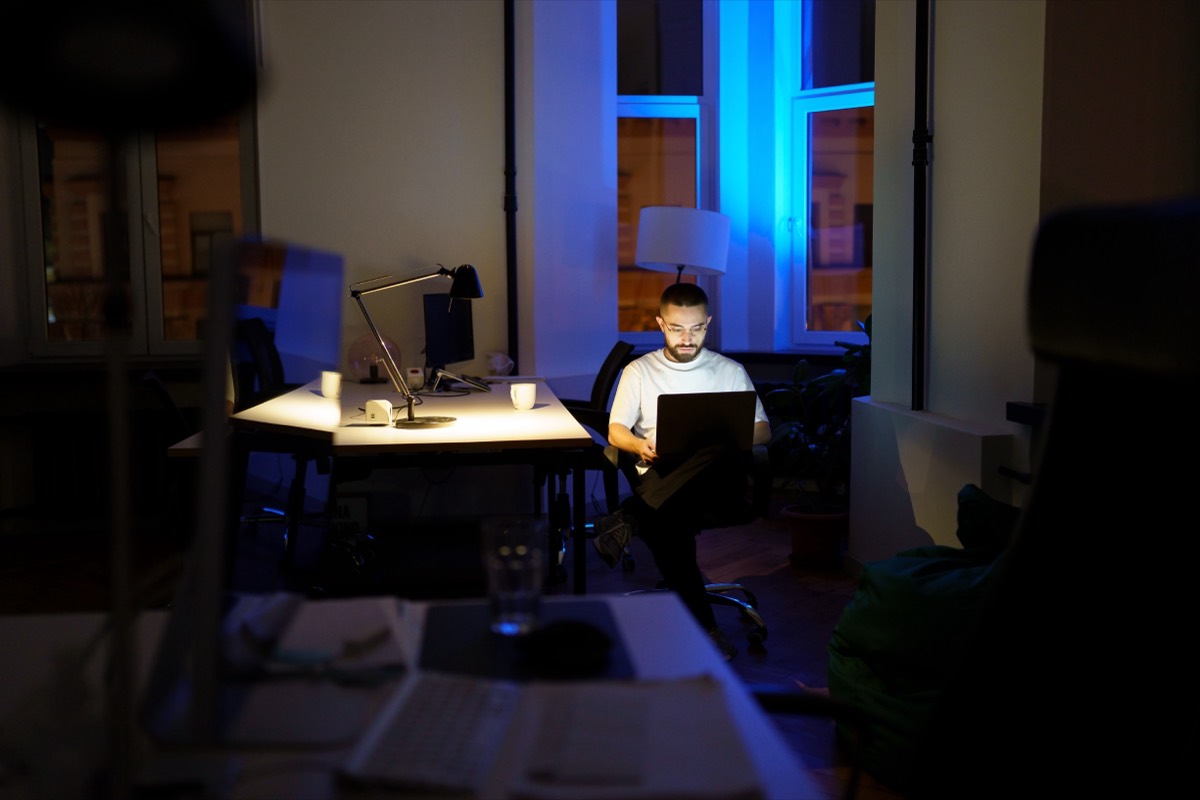 An office lit only by a laptop, long after closing time
